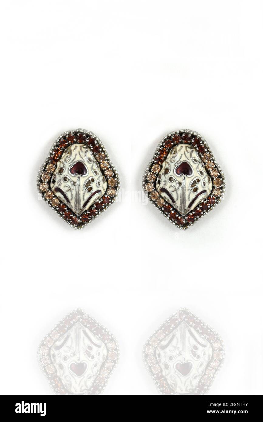 Silver stud earrings with diamond on white background Stock Photo