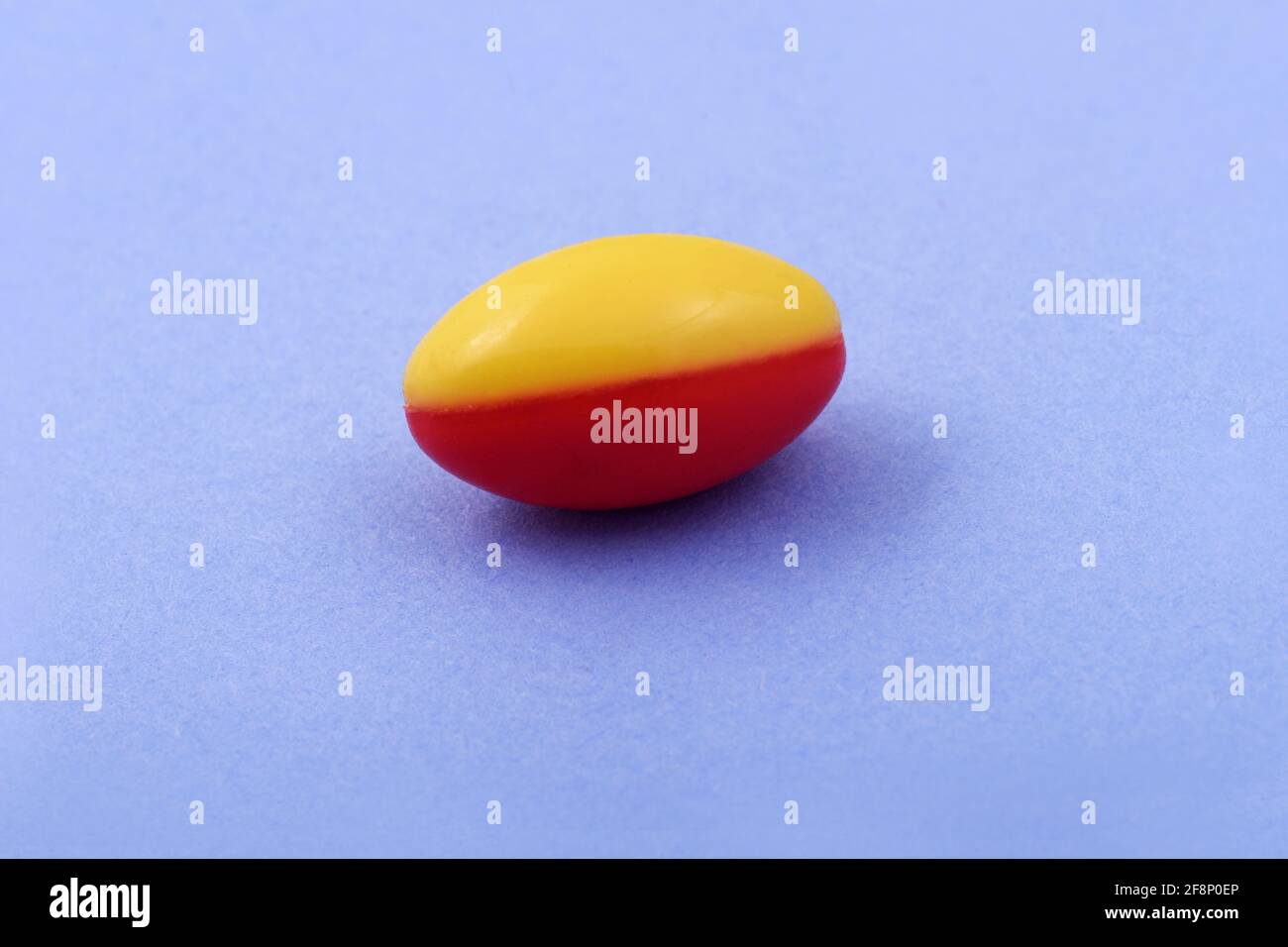 Red and yellow capsule Pharmaceutical medicine tablet on Blue background, Flat lay Copy space Medicine concepts Light blue color background Stock Photo