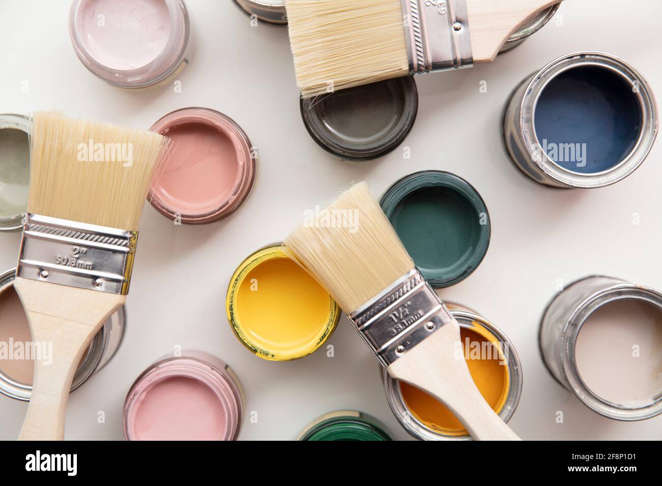 Overhead view of a DIY paint brush with colorful sample paint pots