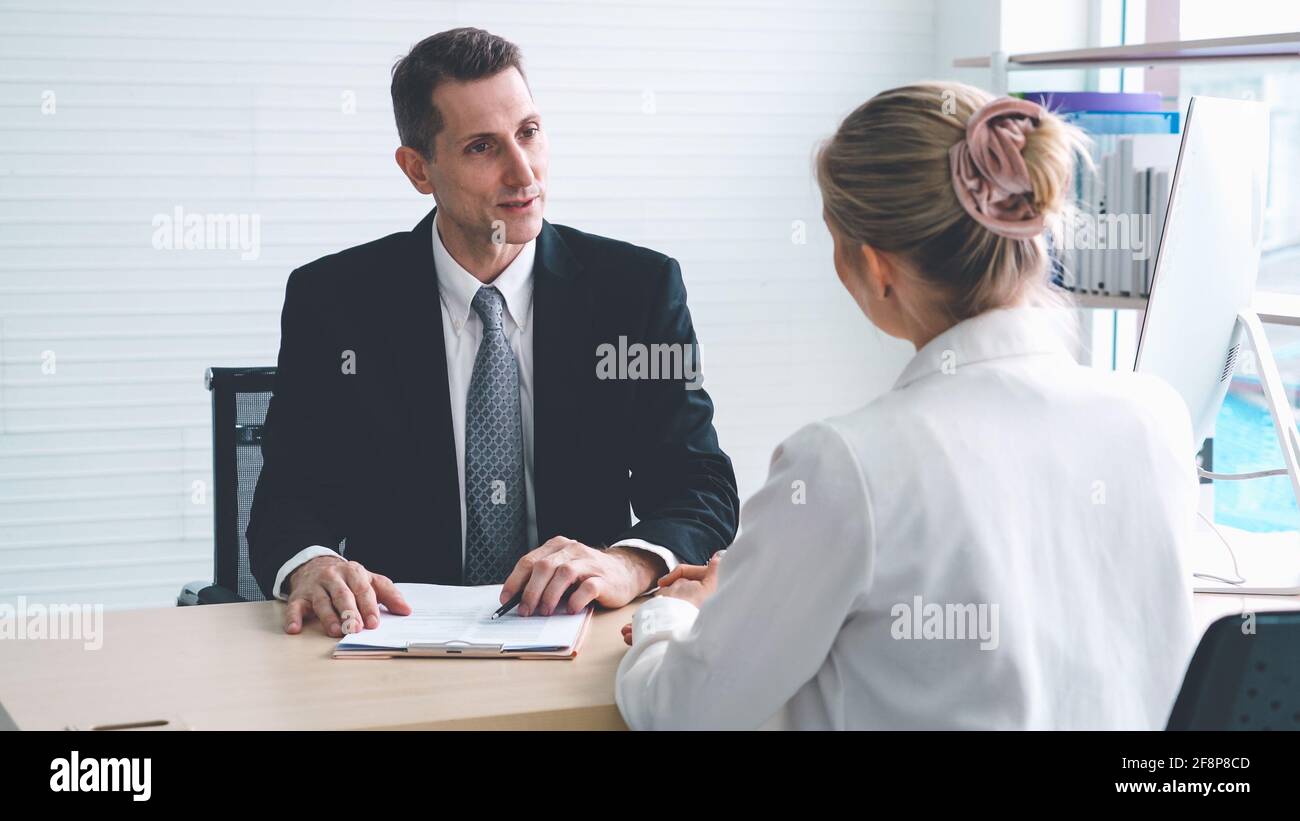 Job seeker in job interview meeting with manager and interviewer at corporate office. The young interviewee seeking for a professional career job Stock Photo