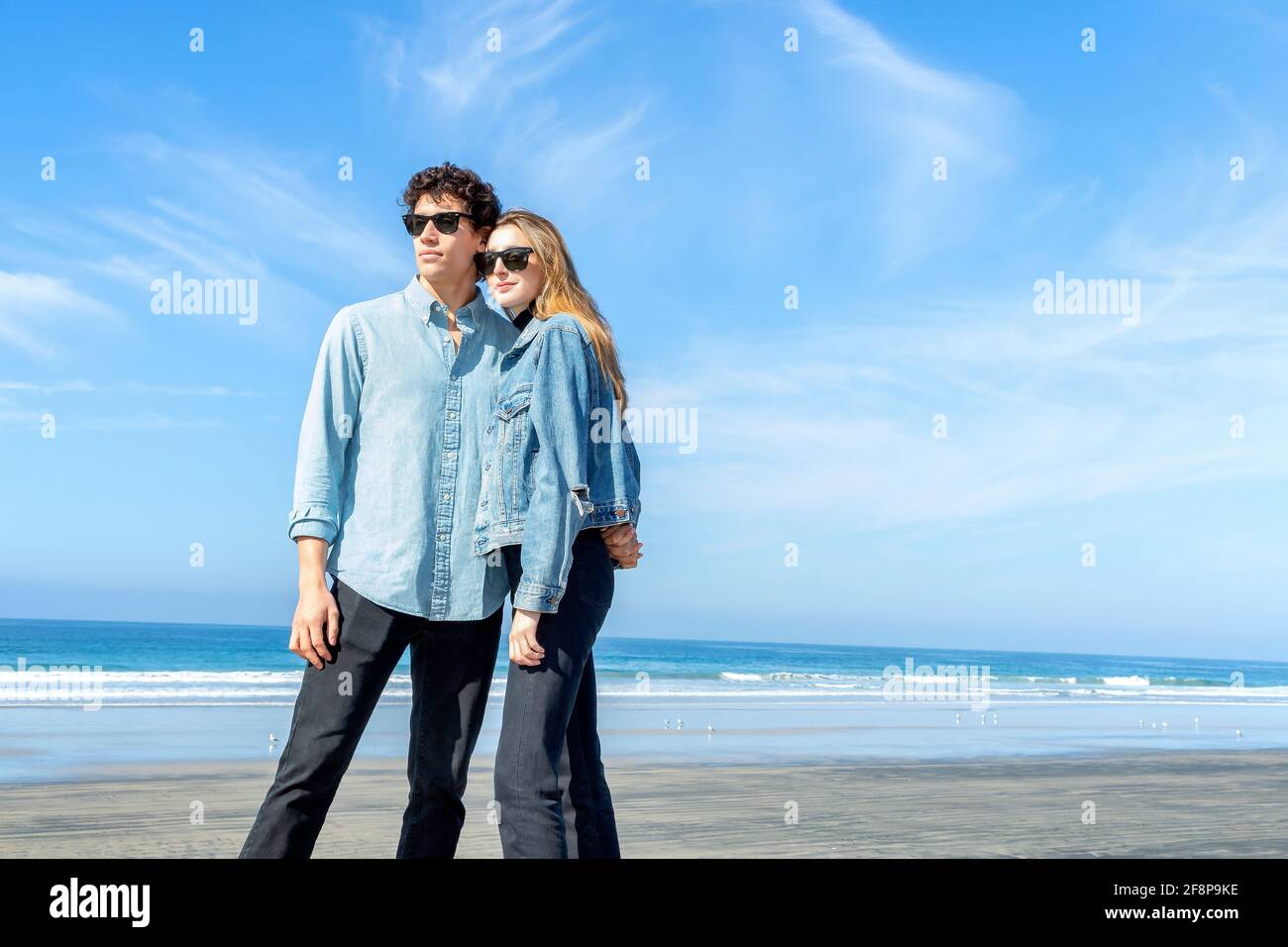 Young couple wearing sunglasses at the beach Stock Photo