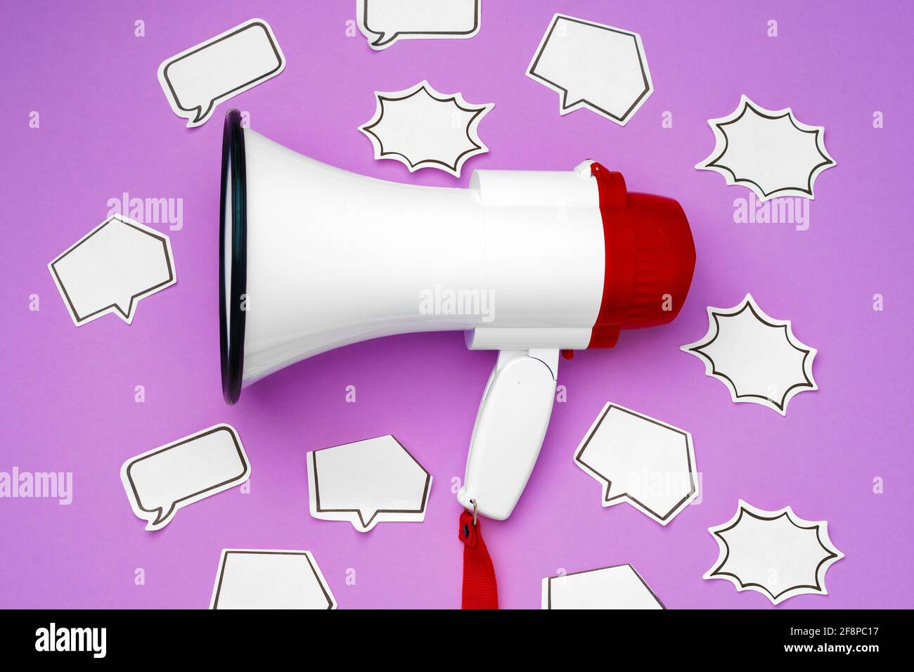 Electronic megaphone and speech bubble on purple background Stock Photo ...