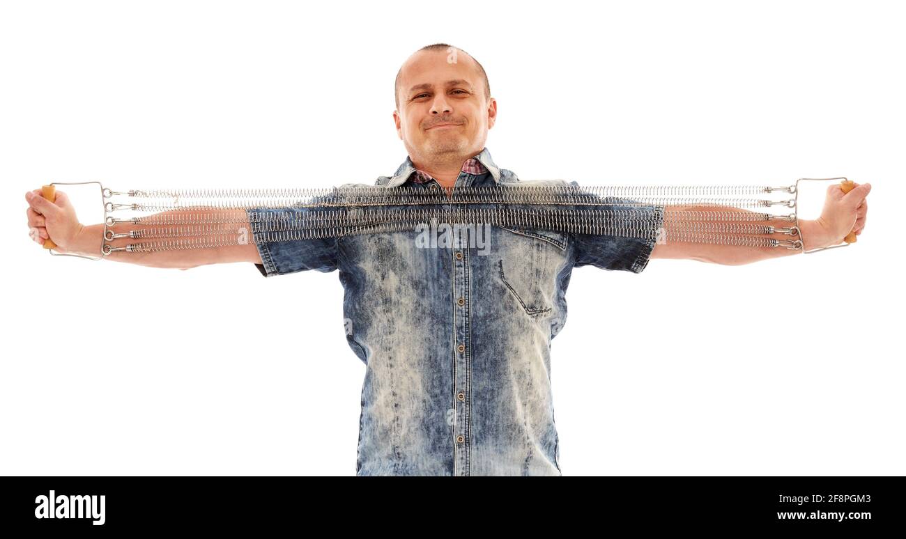 Strong businessman stretching a steel spring expander isolated on white ...
