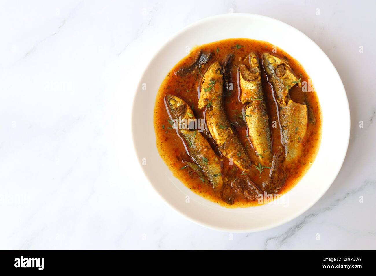 Indian fish curry. White Mullet fish curry made with dried mango and