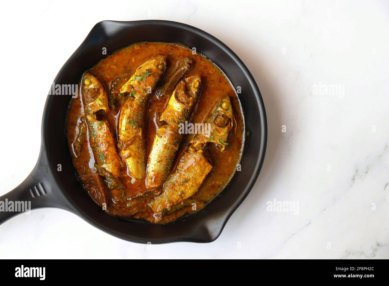 Indian fish curry. White Mullet fish curry made with dried mango and