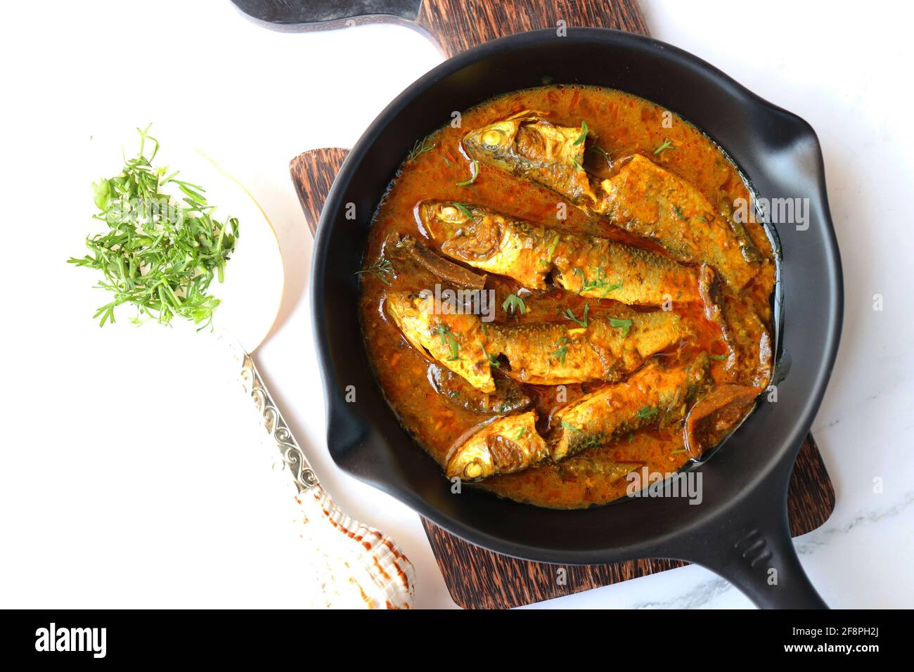 Indian fish curry. White Mullet fish curry made with dried mango and