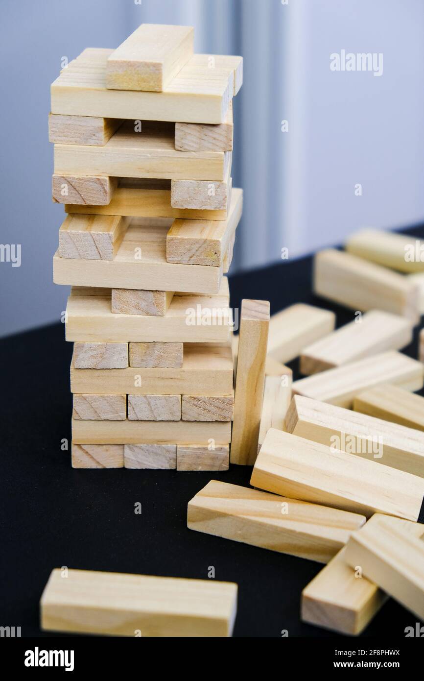 Building from wooden blocks. Wood blocks stack game with Hand on ...