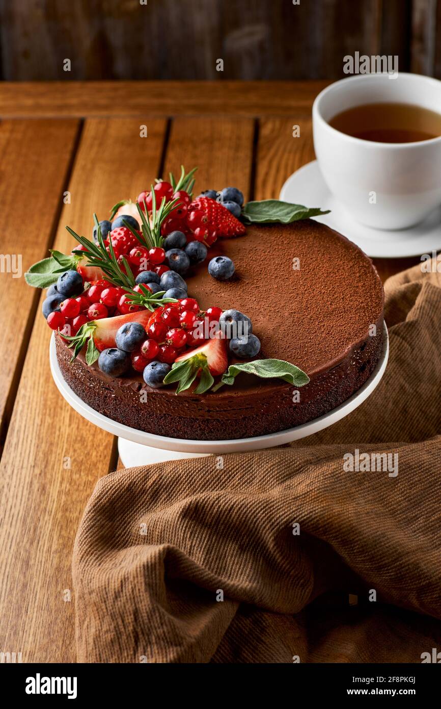 Chocolate cake from chocolate pancakes with icing, with blueberries. Copy space, selective focus Stock Photo