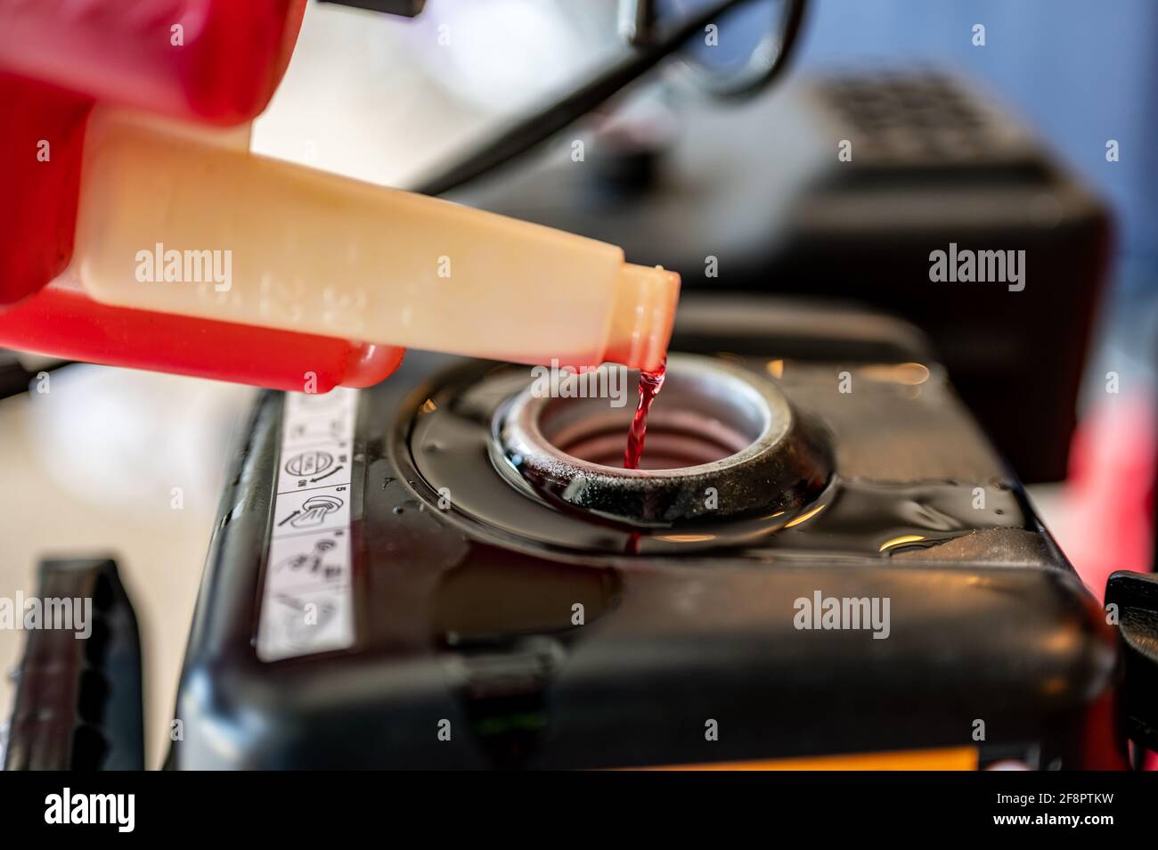 Open gas tank with stabilizer fuel additive being put in before storage