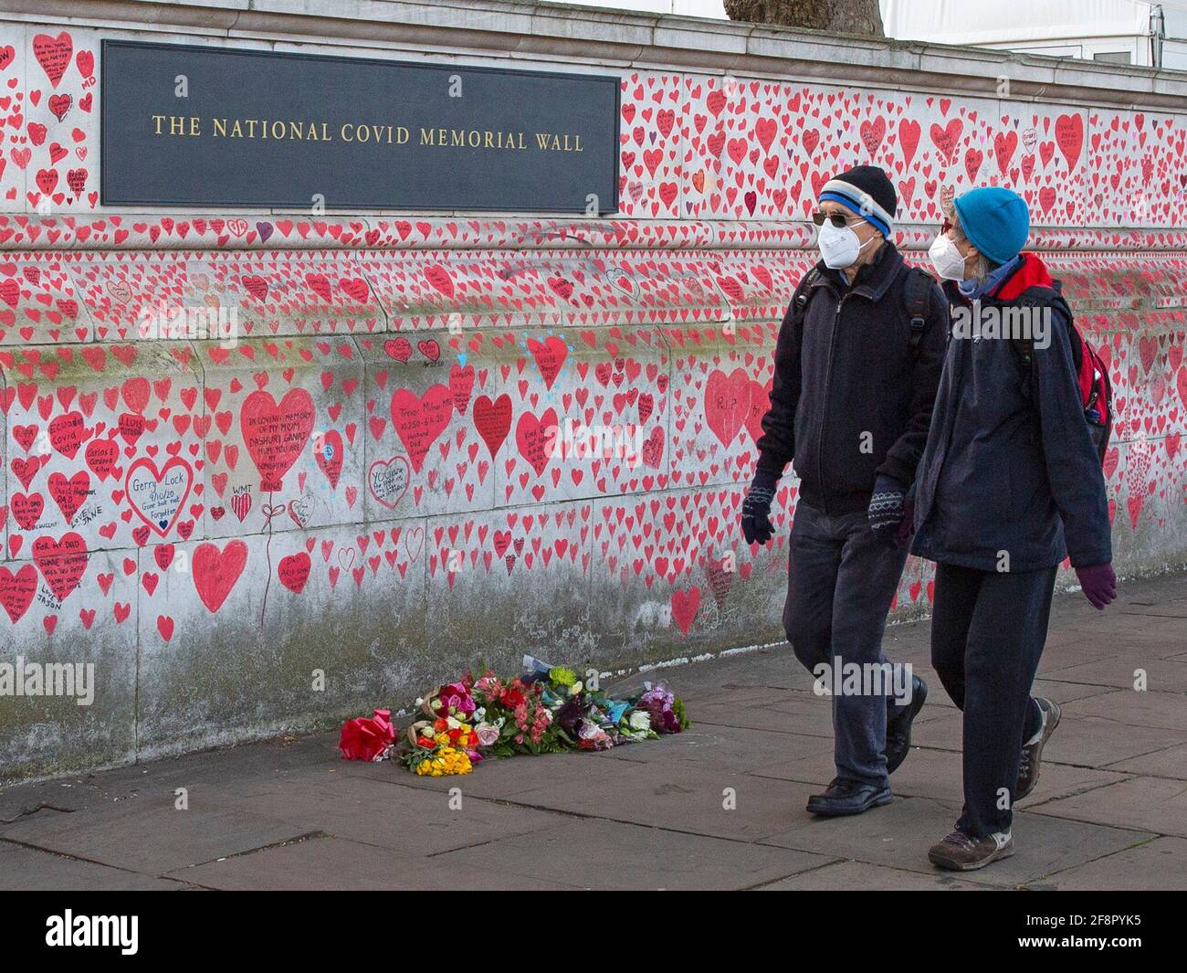 People walk past and write on the national Covid memorial wall, in London on the 9th of April 2021 Stock Photo