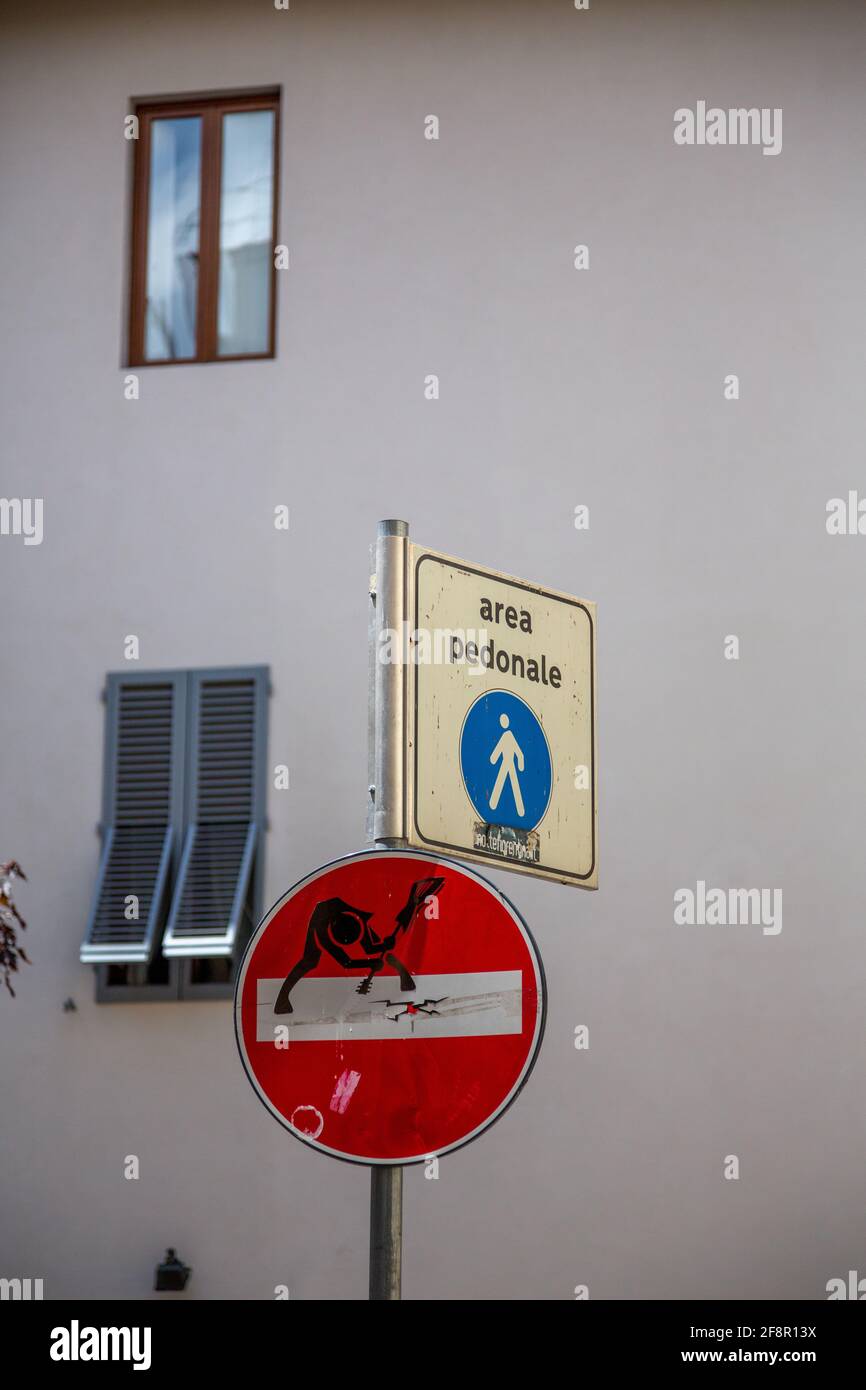 A Guitar Player Smashes a Guitar on a Do Not Enter Sign with a Pedestrian Sign in Florence, Italy Stock Photo