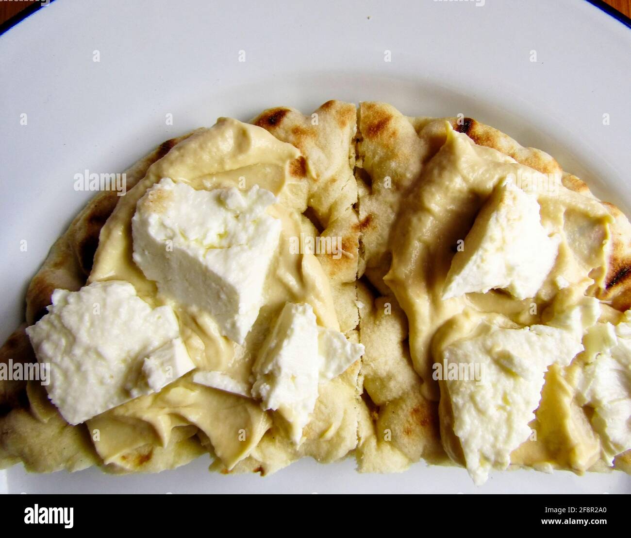Gourmet Hummus with Tahini and Feta Cheese on Pitta Bread Stock Photo