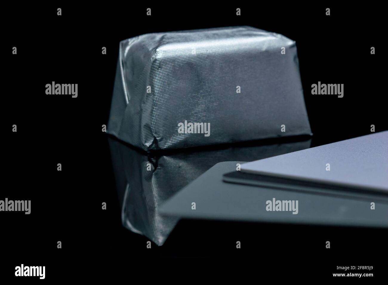 Abstract, creative photo of rectangular shaped candy in shiny packaging ...