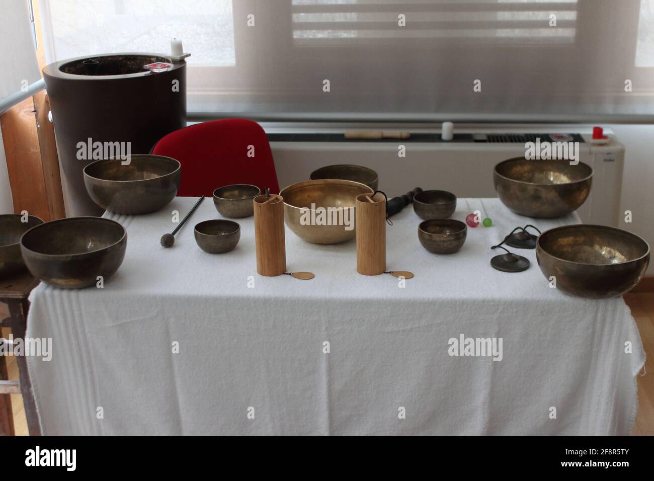 a table full of Tibetan gongs and bells ready for meditation therapy
