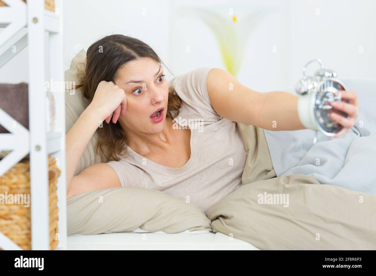 young sleeping woman waking up late Stock Photo Alamy
