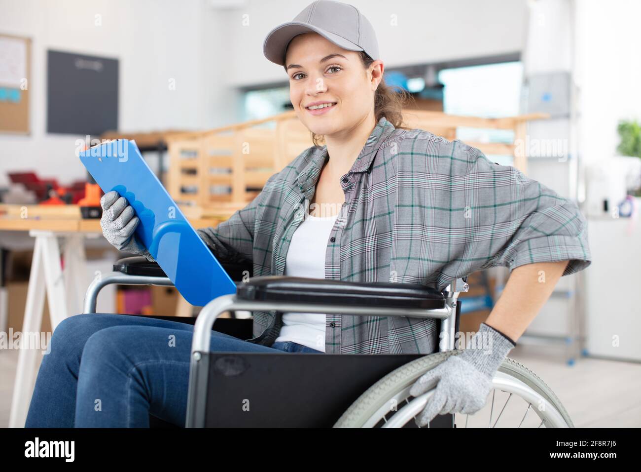 disable female carpenter using a saw Stock Photo