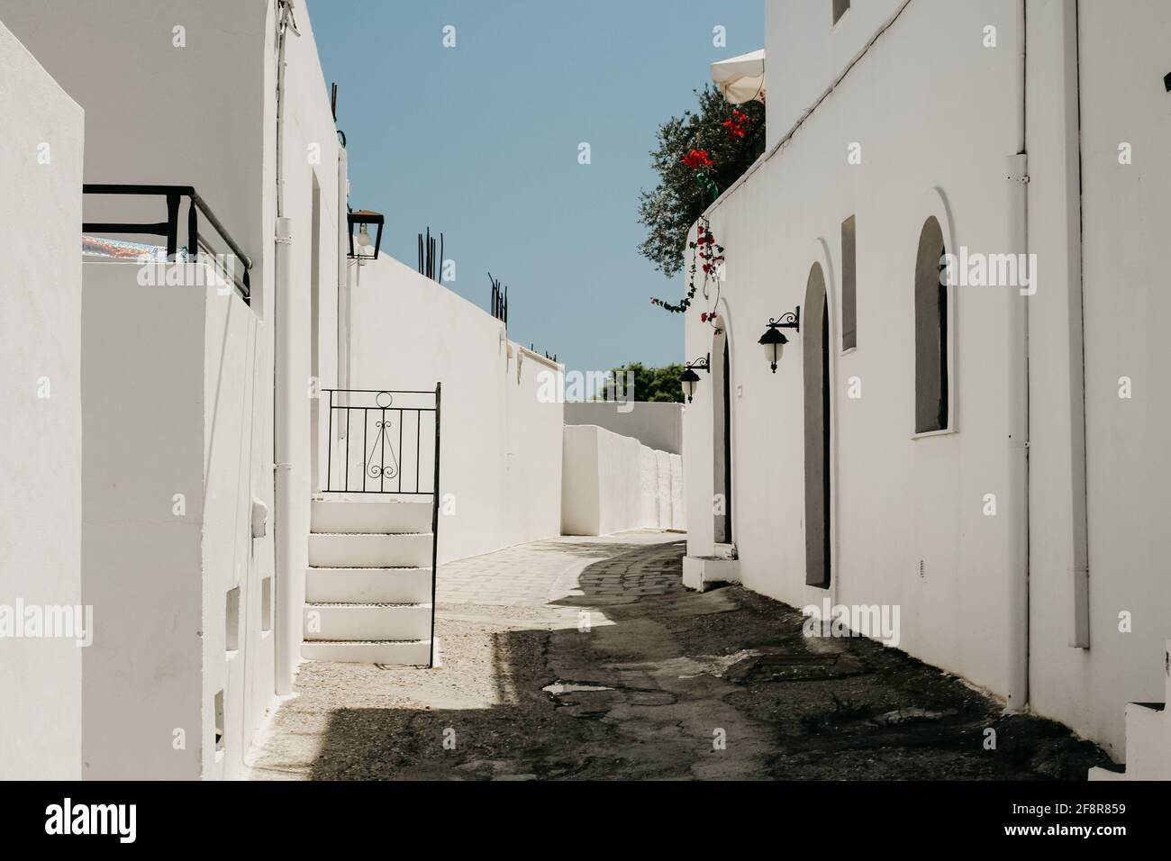 Town with white buildings under a clear sky on a sunny day in Greece Stock Photo