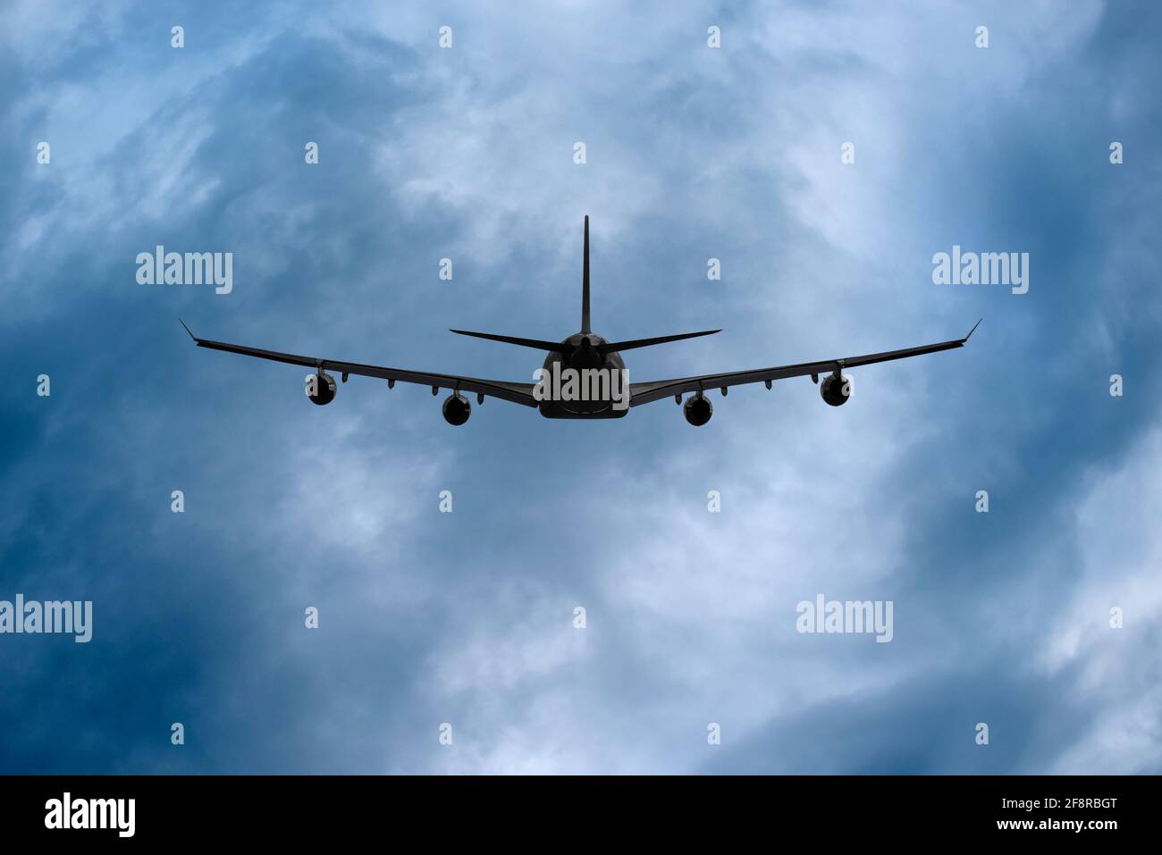 Airplane in Storm Clouds Stock Photo