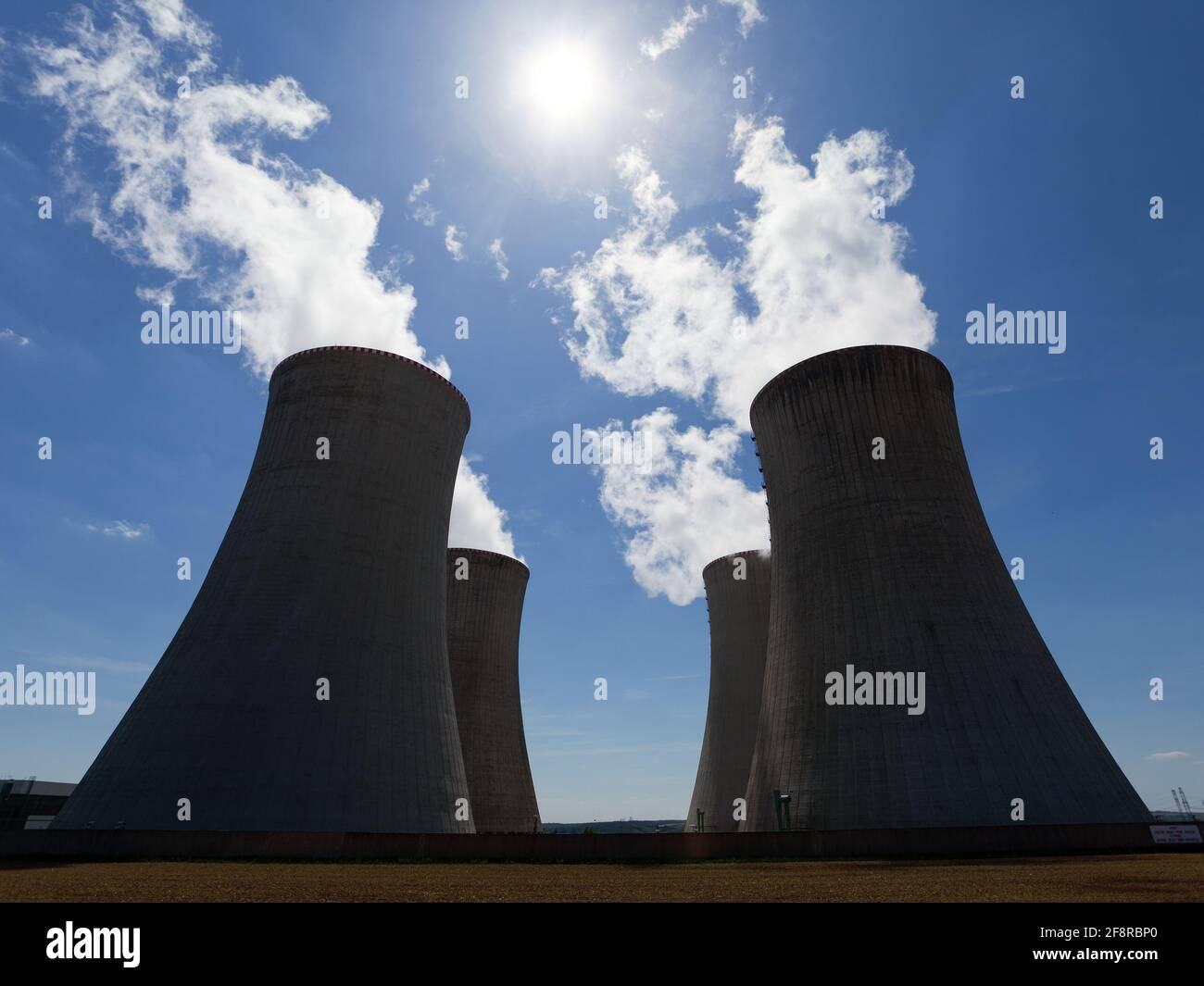 Nuclear power plant Dukovany - cooling towers with contrejour lighting and beautiful sky - Czech Republic Stock Photo