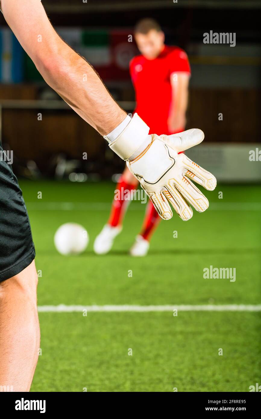 Man scoring a goal at indoor football or indoor soccer Stock Photo