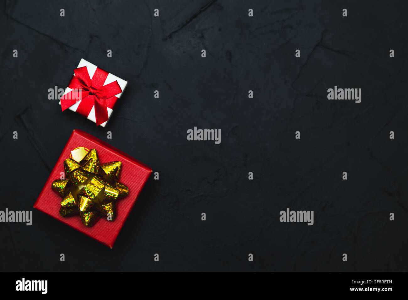 Gift boxes on a dark background. Flat lay, low key. Stock Photo