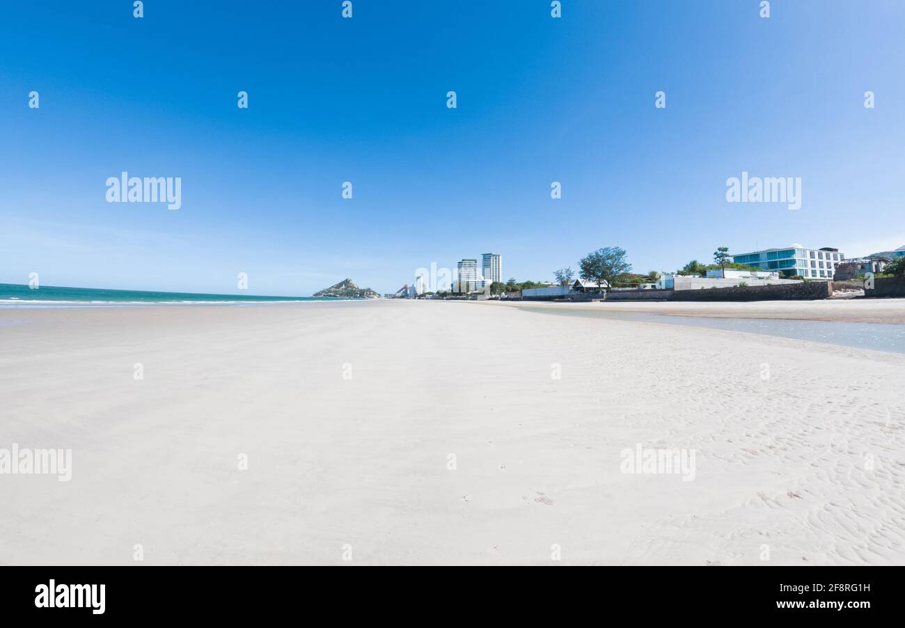 Beautiful beach with white sand, turquoise ocean water and blue sky with clouds in sunny day. at Huahin Thailand Stock Photo
