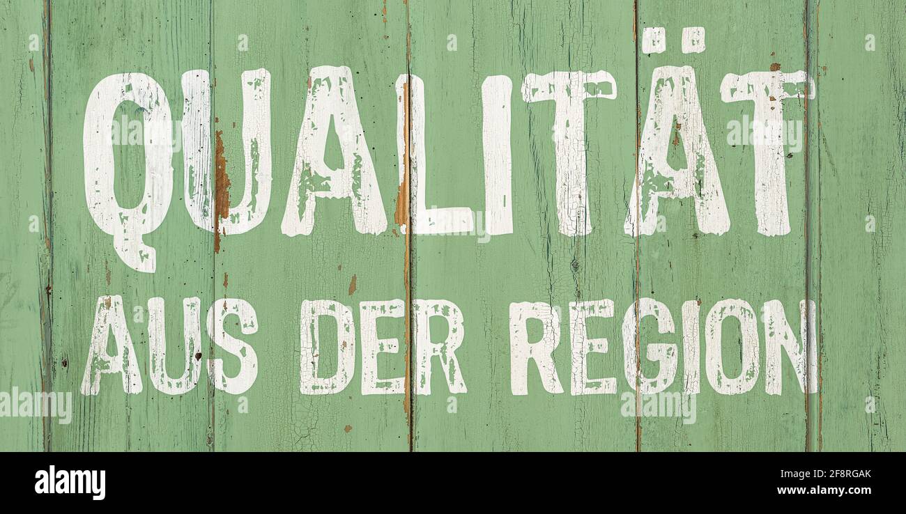 Wooden retro sign - Regional Quality in german - Qualität aus der Region Stock Photo