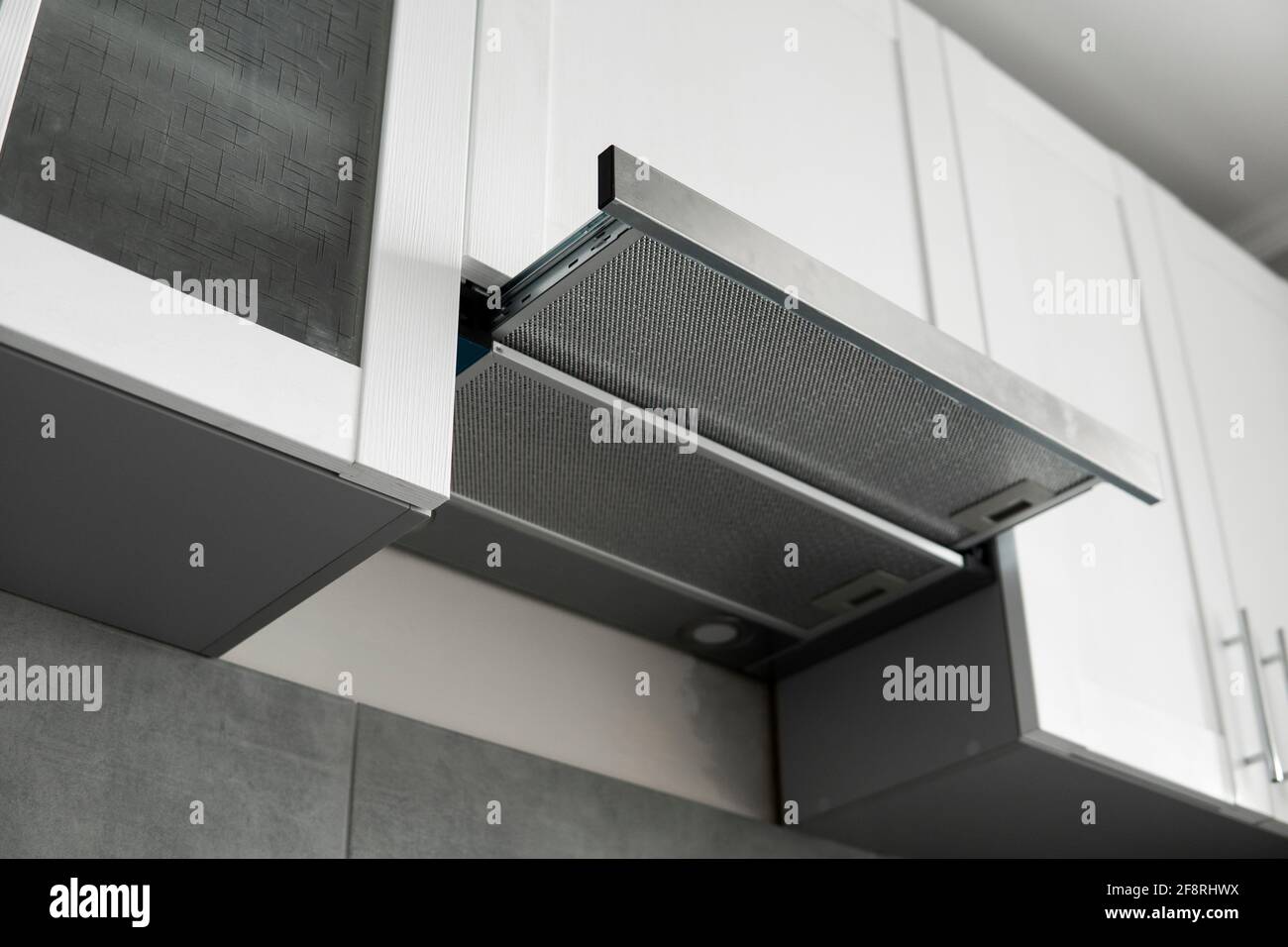 Grey stainless cooking glass hood on modern white minimalist style