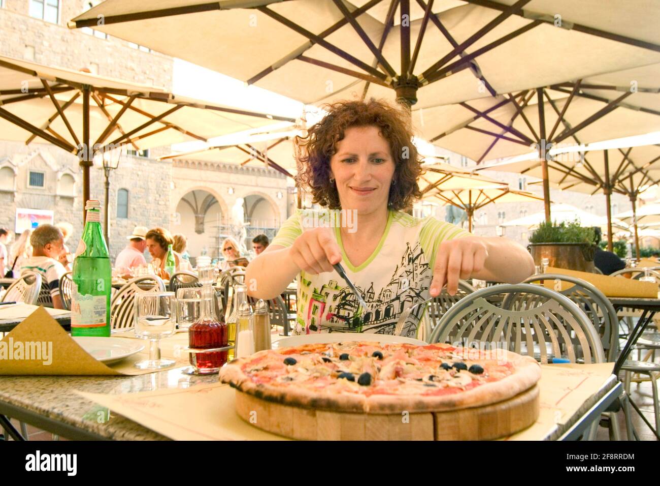 woman eating pizza, Austria Stock Photo