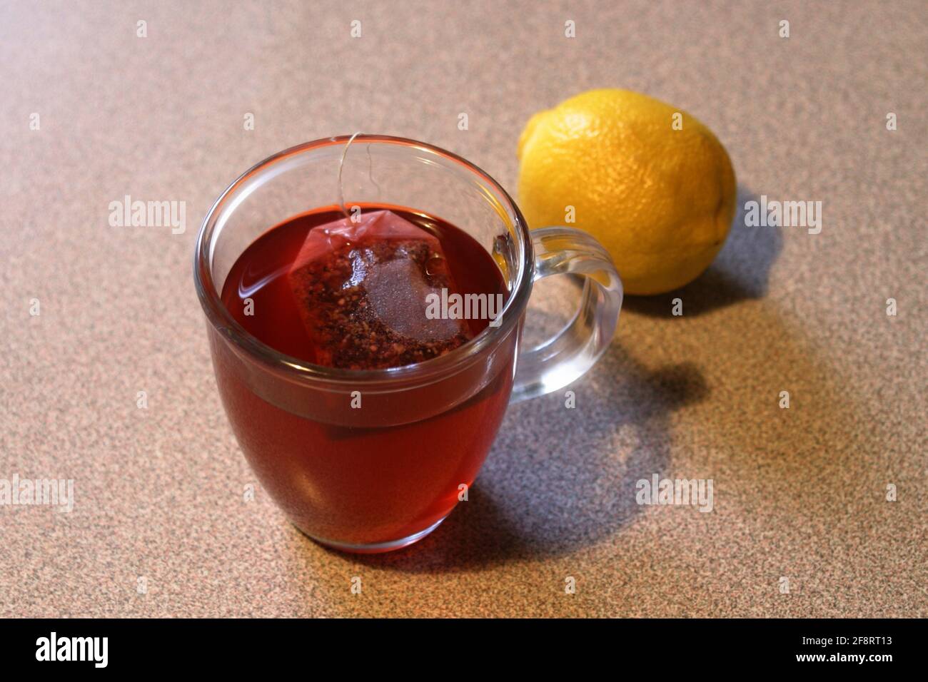 lemon (Citrus limon), tea glass with tea bag and lemon, Ã–sterreich Stock Photo