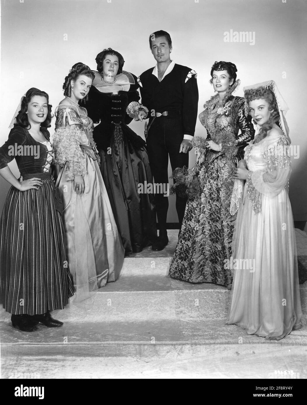 BARBARA BATES HELEN WESTCOTT VIVECA LINDFORS ERROL FLYNN JEANNE SHEPHERD and MARY STUART Publicity Pose for ADVENTURES OF DON JUAN 1948 director VINCENT SHERMAN story Herbert Dalmas music Max Steiner art direction Edward Carrere costume design Leah Rhodes Travilla and Marjorie Best Warner Bros. Stock Photo