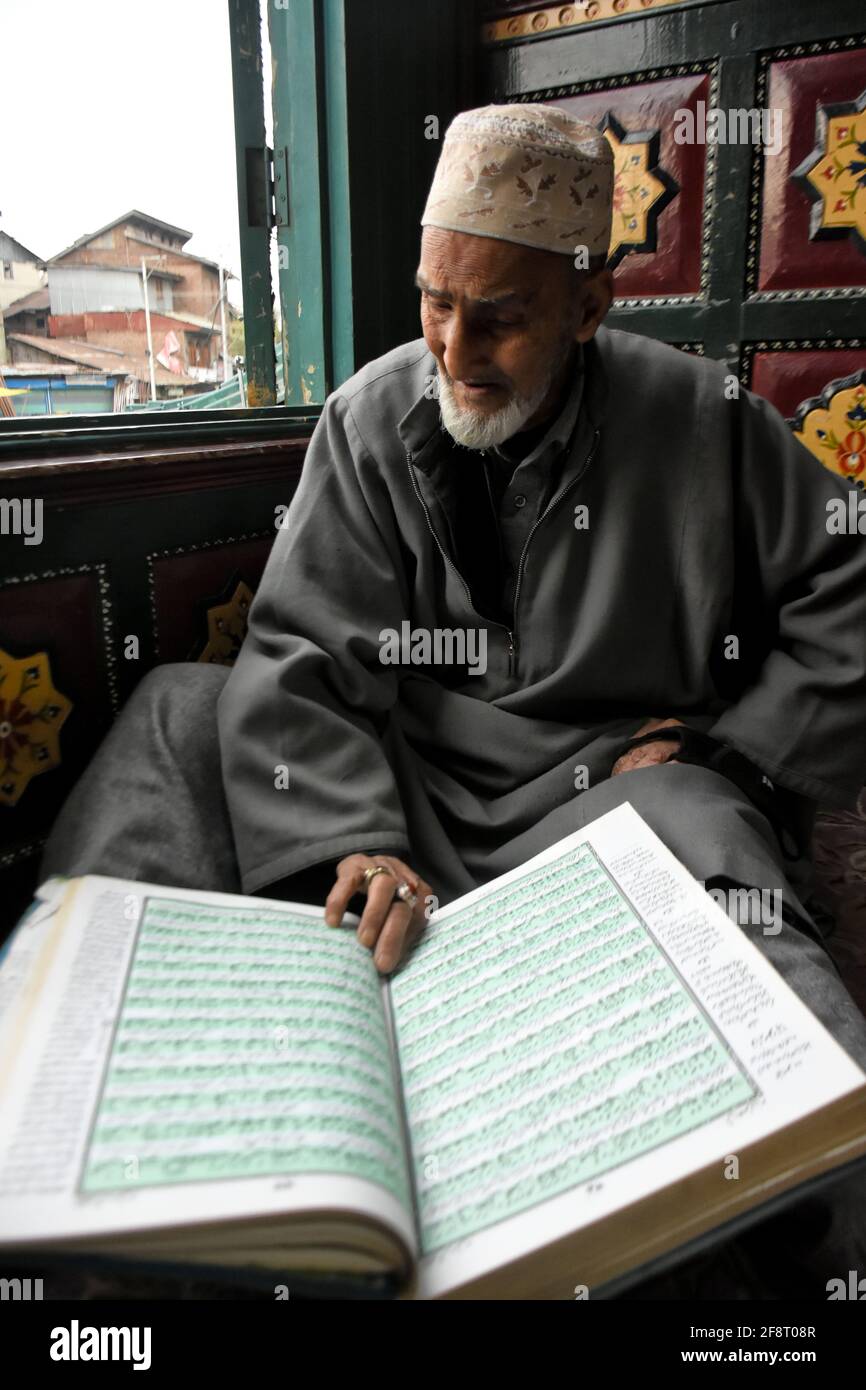 April 14, 2021: A Kashmiri man reads Holy Quran on the first day of ...
