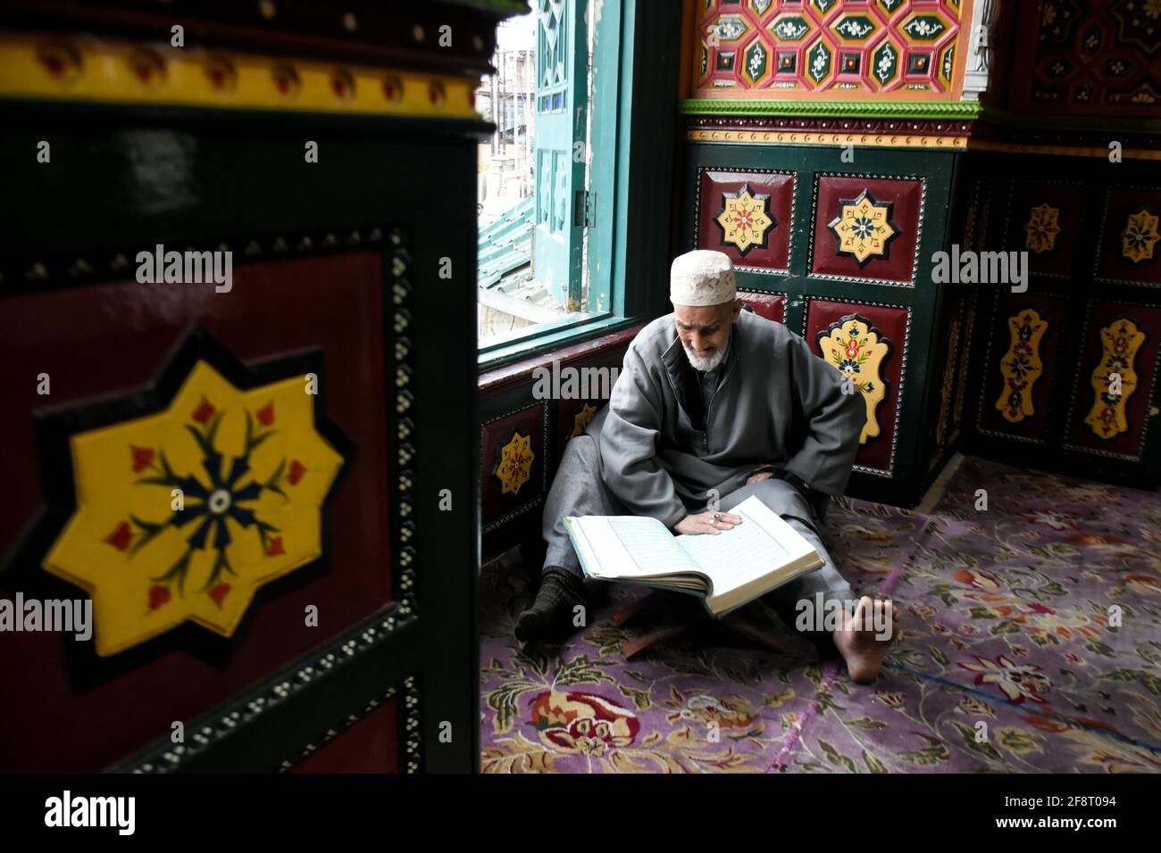 April 14, 2021: A Kashmiri man reads Holy Quran on the first day of ...