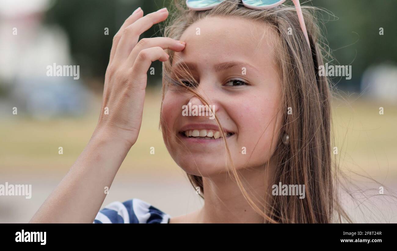Portrait of a young smiling girl in the park on a summer day Stock ...