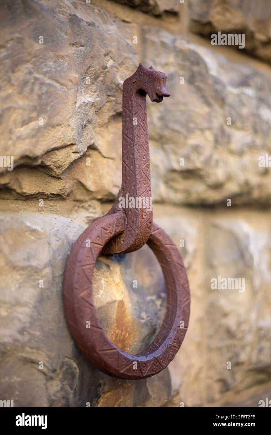 Rusted Horse Hitching Ring on an Old Stone wall Stock Photo