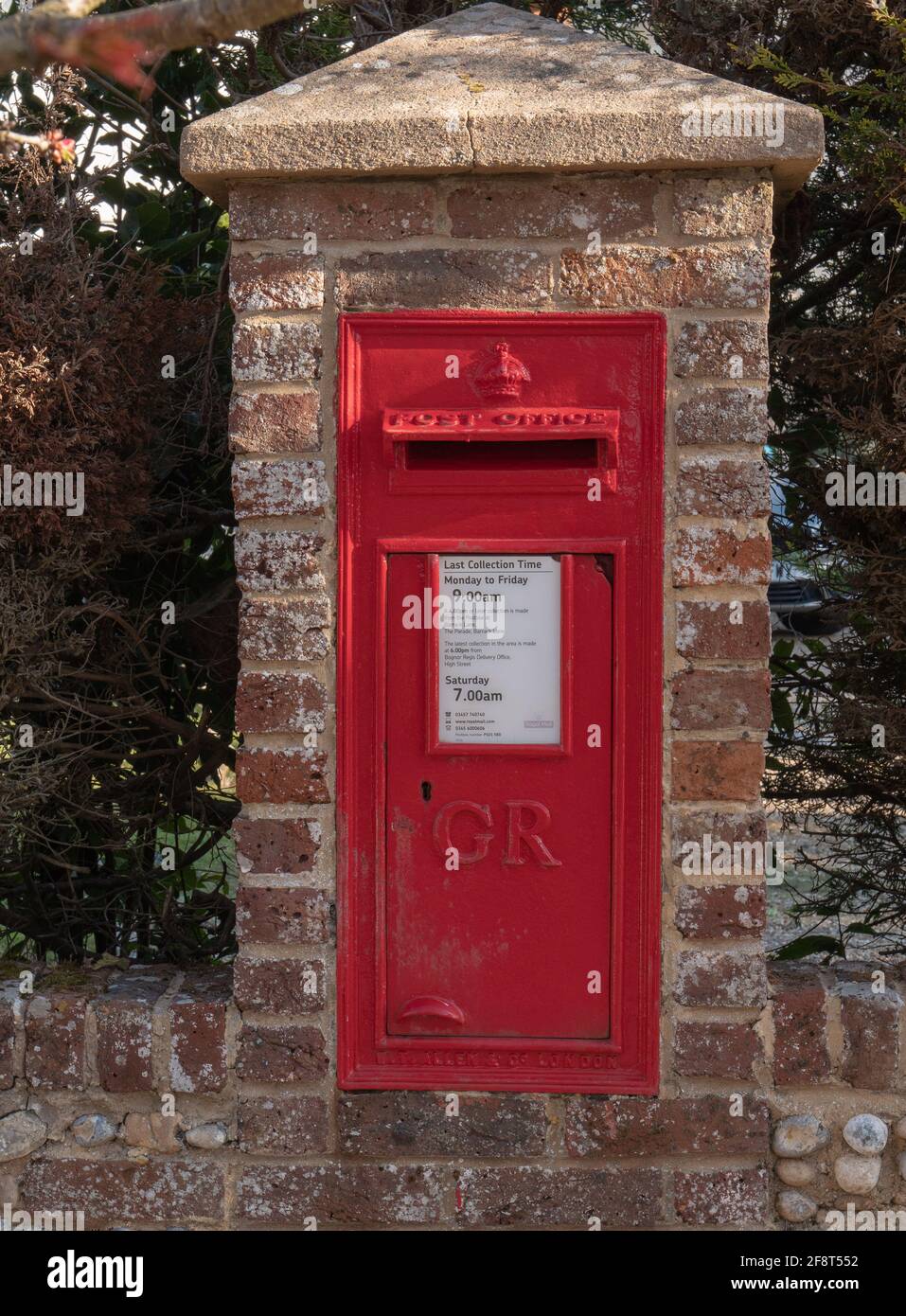 UK letterbox seen in a wall outside. Stock Photo