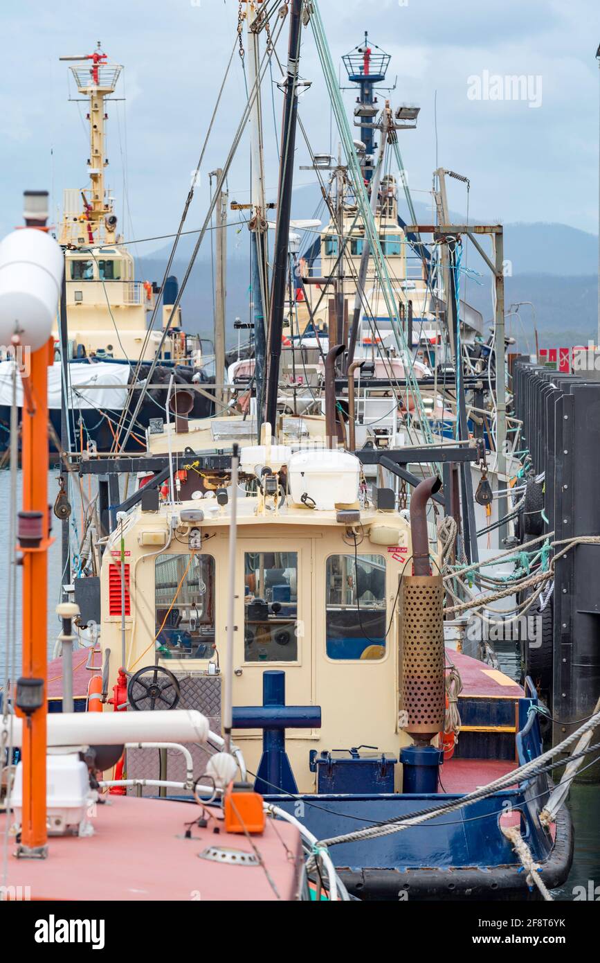 A line of commercial fishing and other boats moored at the Port of Eden on the New South Wales south coast of Australia Stock Photo