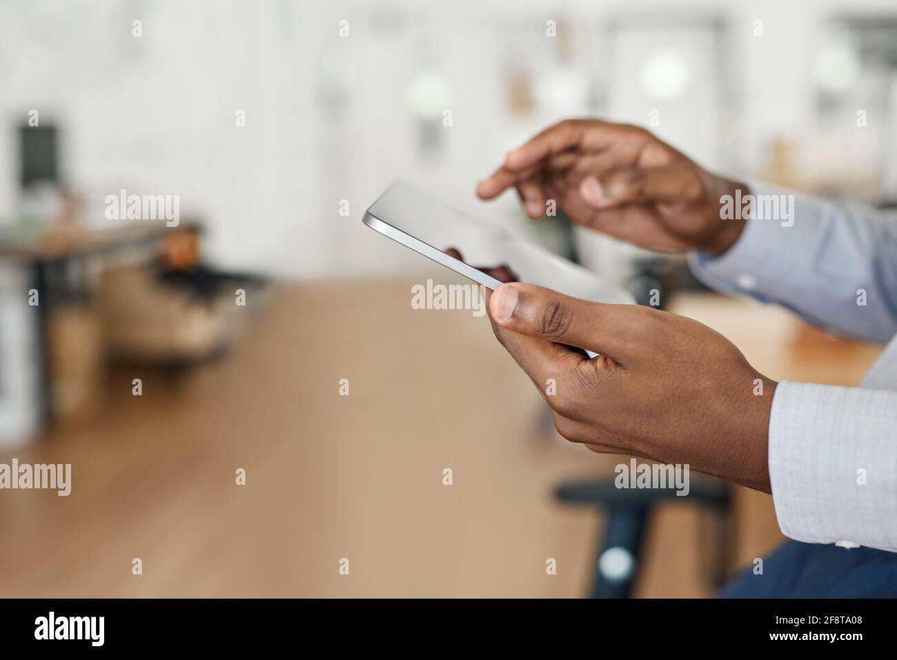 Closeup of an African businessman working with a digital tablet Stock Photo