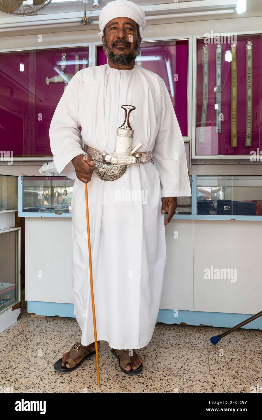 Senior Omani man wearing the traditional khanjar in the town Ibra, Oman. Stock Photo