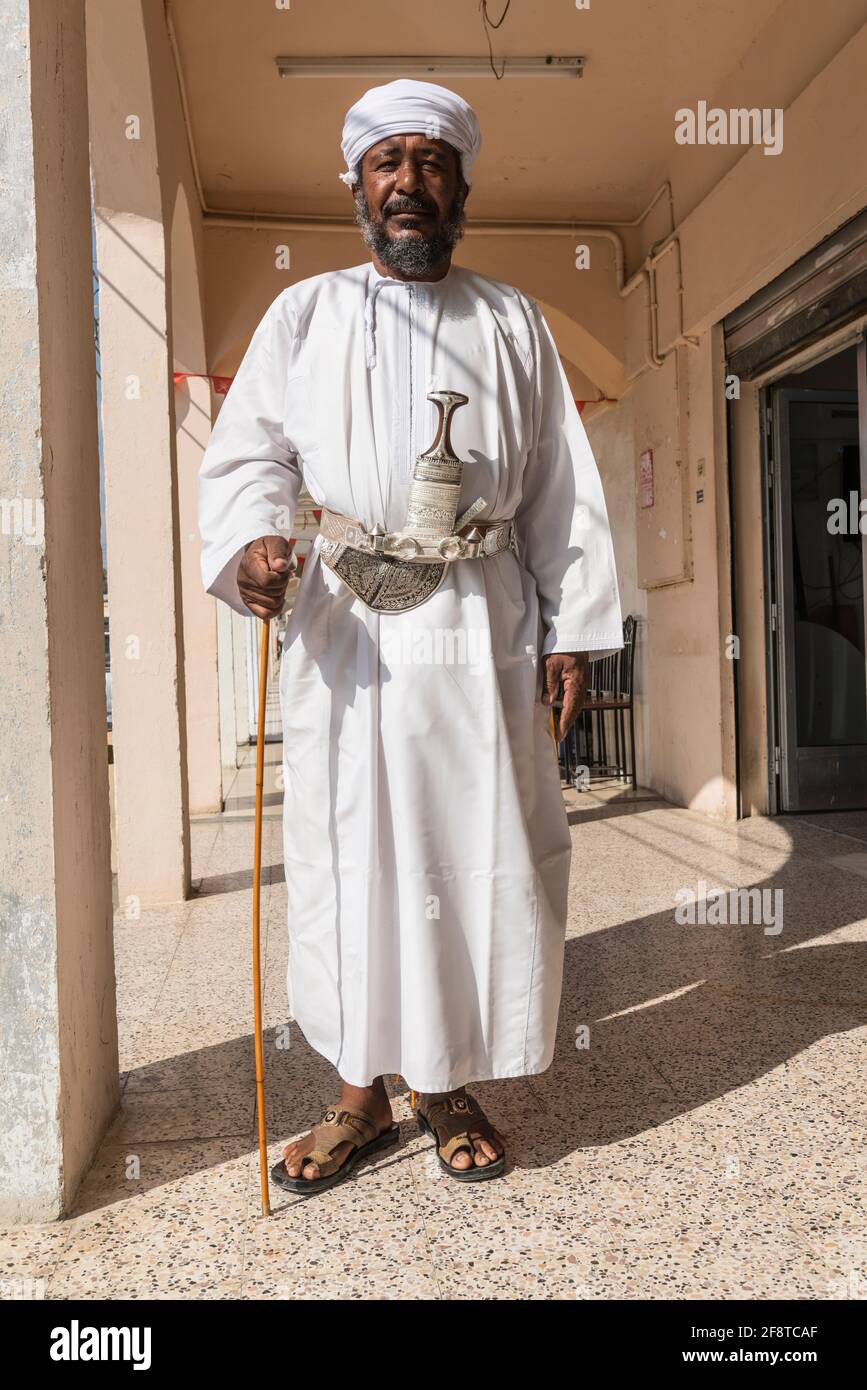 Senior Omani man wearing the traditional khanjar in the town Ibra, Oman