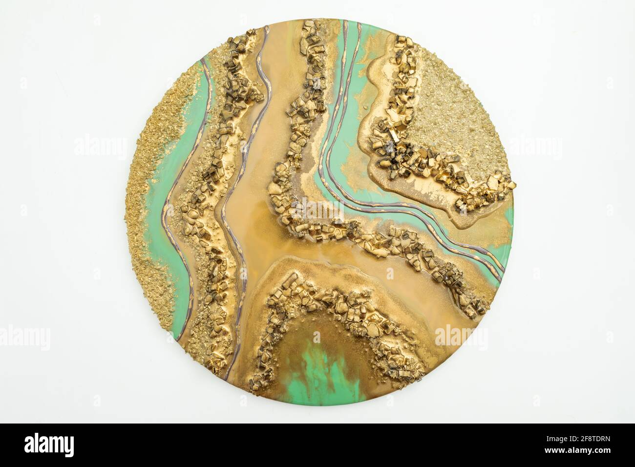 Round resin art painting with golden colors and glass. Stock Photo