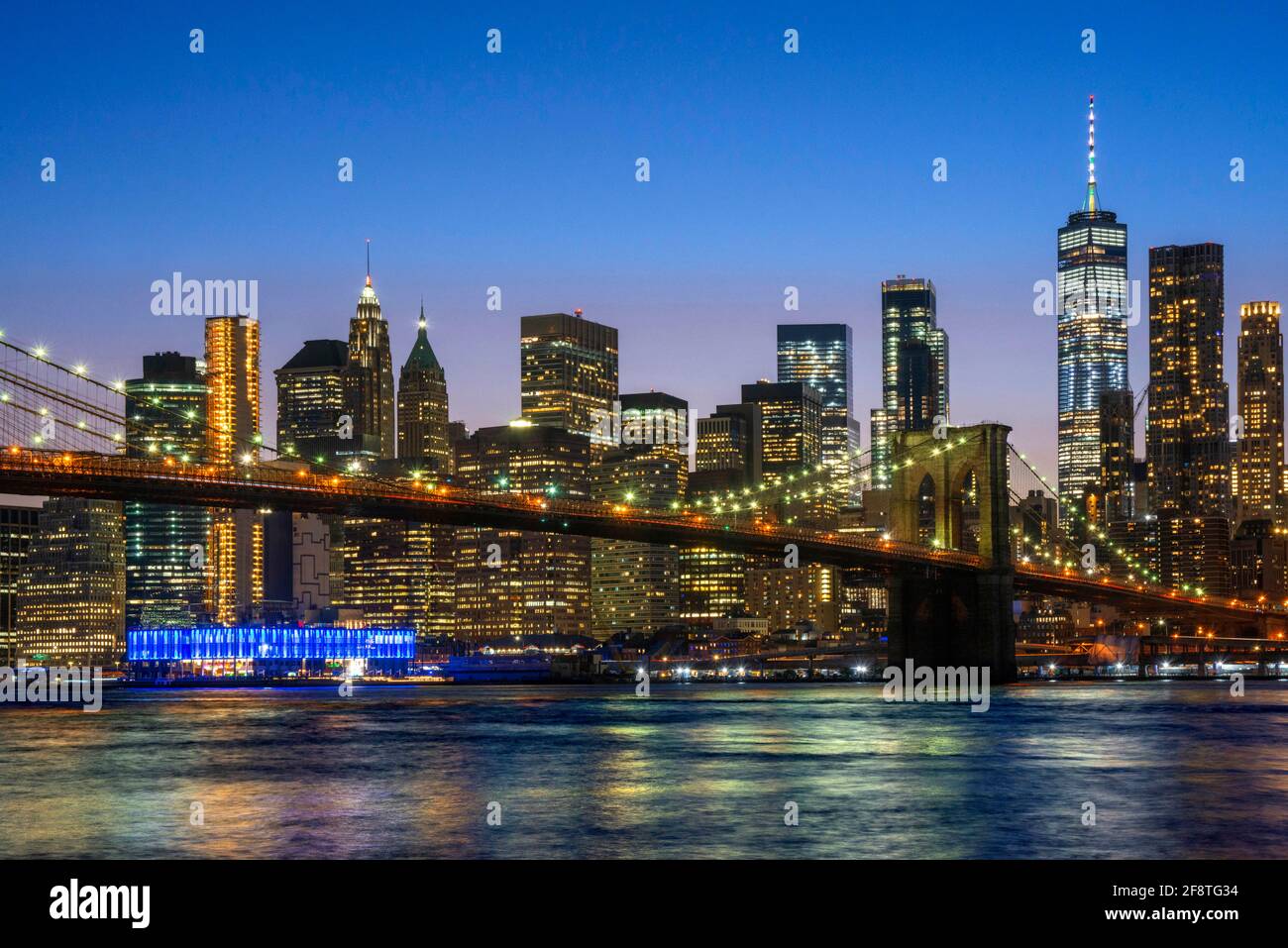Brooklyn Bridge, New York with Manhattan skyline and Pier 16 and Pier