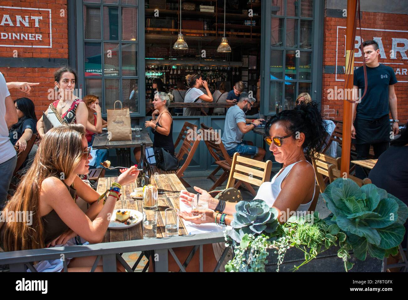 Alfresco dining at Gelso & Grand Italian bar restaurant terrace in 186 Grand Street with Mulberry Street in Little Italy, New York City Stock Photo