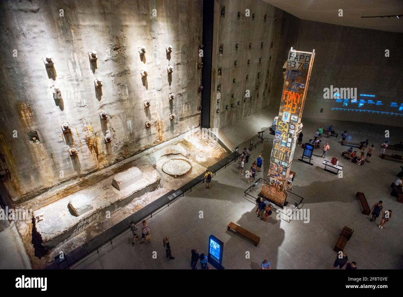 9/11 Memorial and Museum interior - looking down at The Last Column; Manhattan New York city USA.  People gathering around the Last Column at the 9/11 Stock Photo