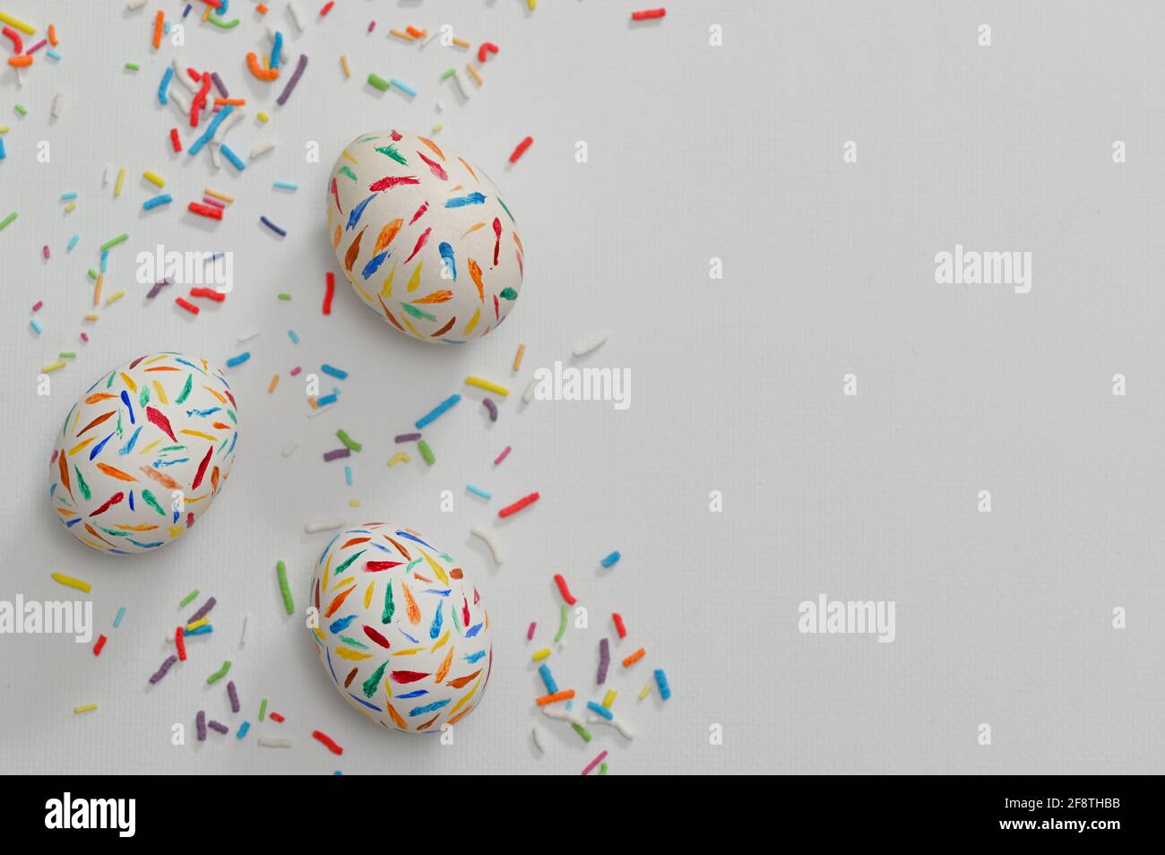 Painted Sprinkle Easter Eggs on white table Stock Photo