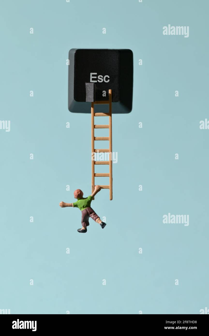 Abstract Escape Key and Miniature People Runaway on Ladder Stock Photo
