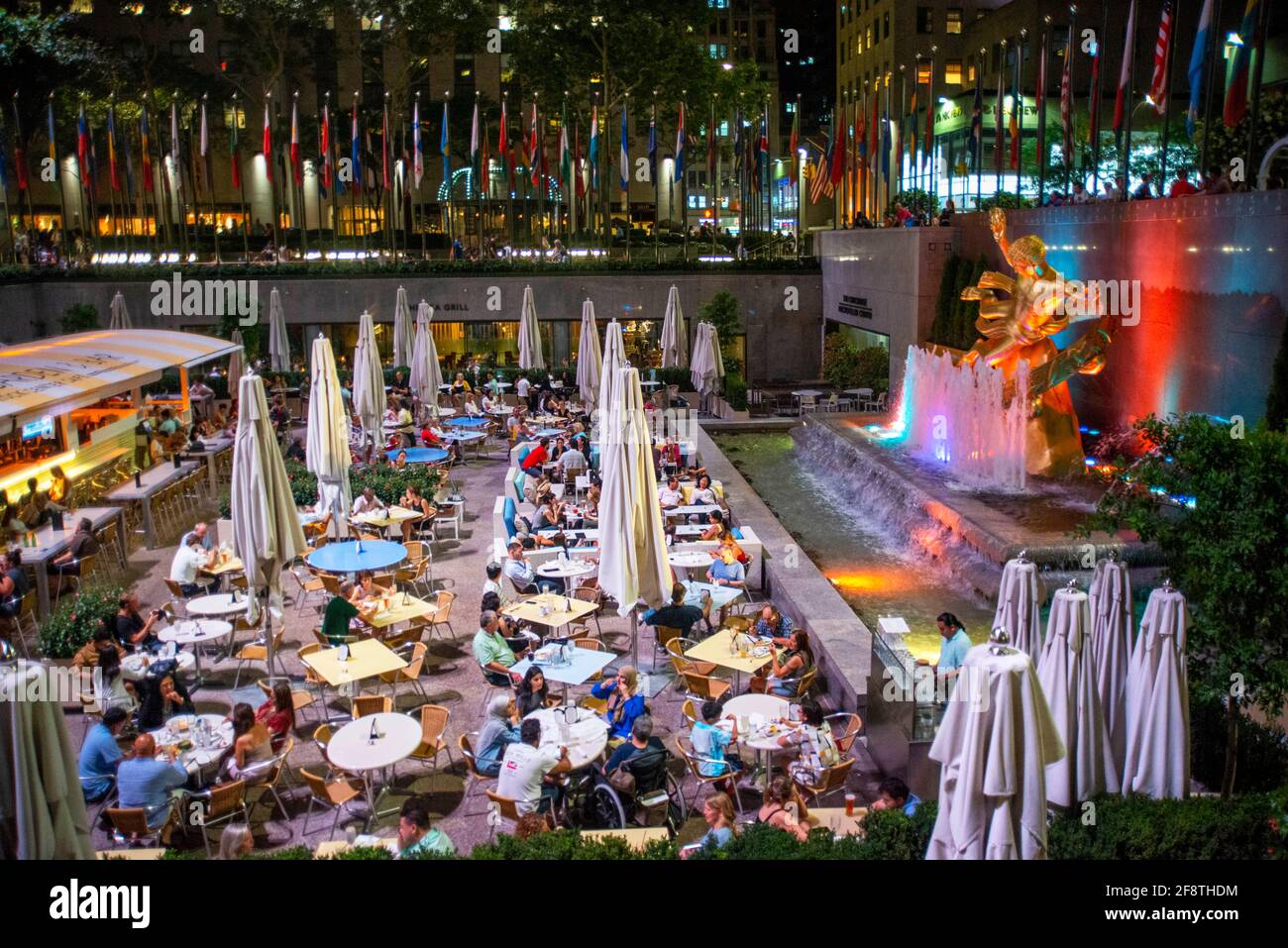The rink at the Rockefeller Center and the summer garden Bar and restaurant and The statue of the Titan God, Prometheus sits above the sunken plaza at Stock Photo