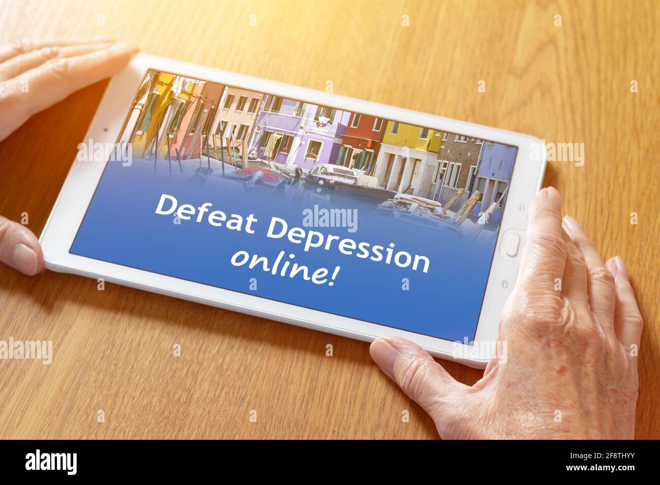 Teletherapy concept for depression: online counseling app on a tablet pc in the hands of an elderly woman. Stock Photo