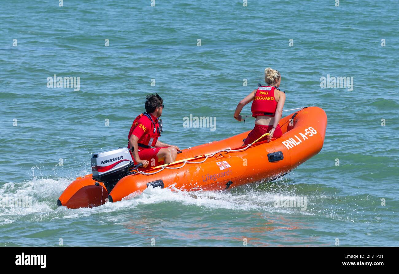 RNLI lifeguards rush to an incident at sea in a Arancia A58 rescue rib in West Sussex, England, UK. Stock Photo