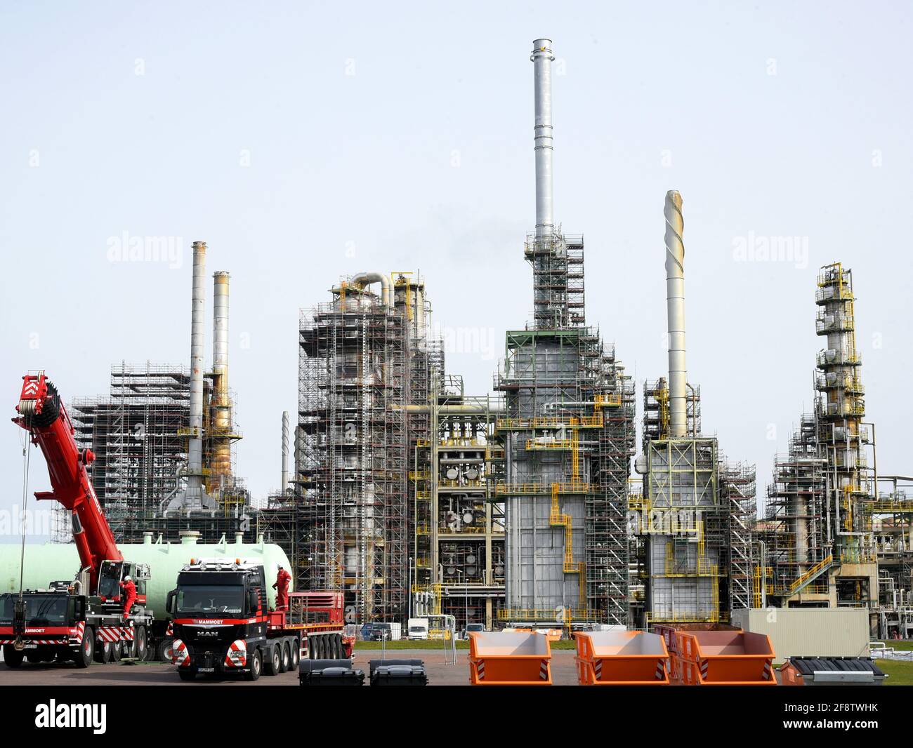15 April 2021, Saxony-Anhalt, Leuna: At the TOTAL refinery in Leuna, construction vehicles stand in front of equipment and columns surrounded by scaffolding. Preparations are currently underway at one of the most modern refineries in Europe for a general inspection lasting several weeks, which is scheduled to begin at the beginning of May. The scheduled general maintenance with complete shutdown of the refinery, which belongs to the French oil company 'Total', was supposed to take place last year, but had to be postponed due to the first Corona wave. Total expects about 5000 additional workers Stock Photo